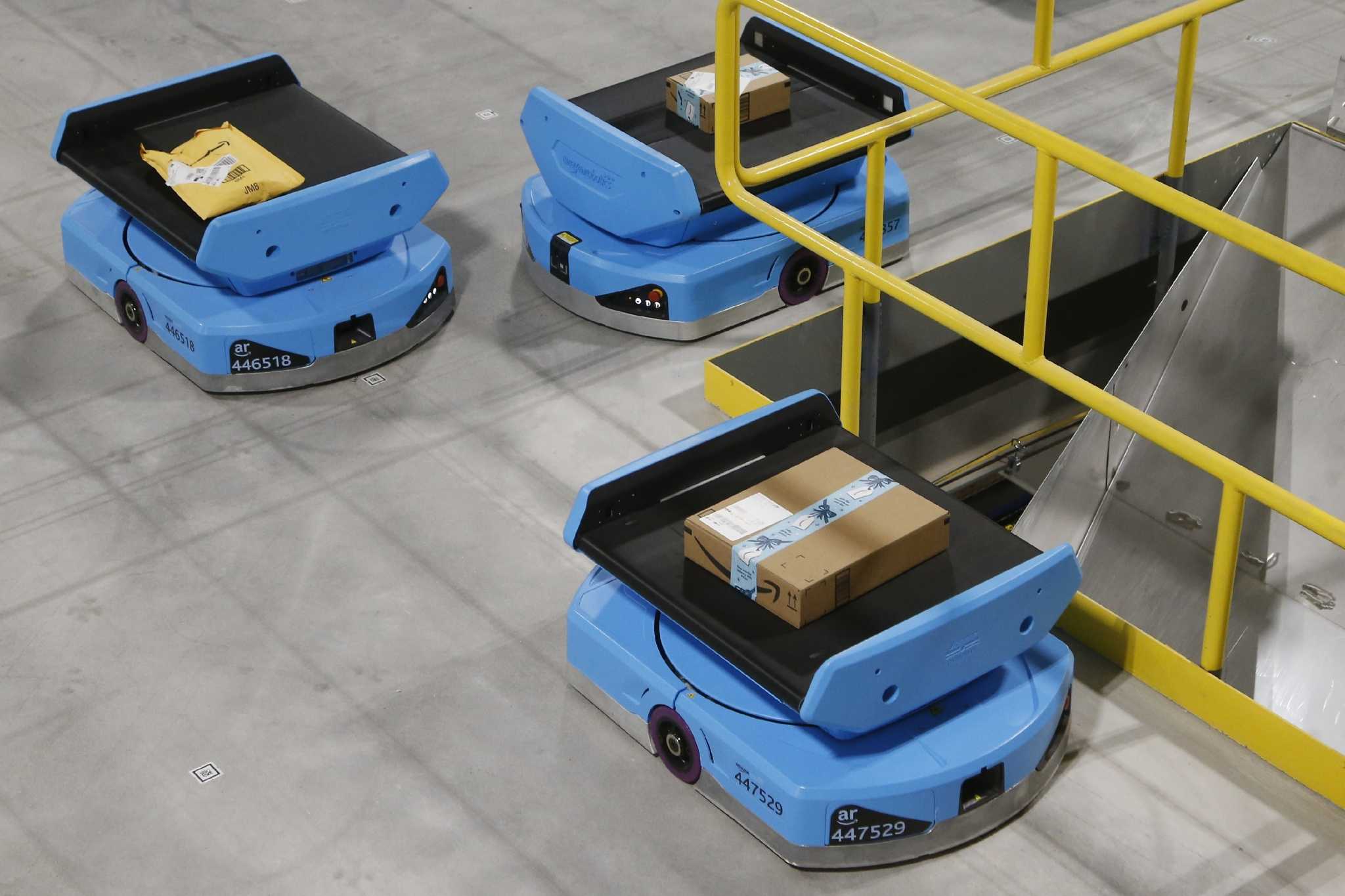 Workers adapt as robots take over the warehouses