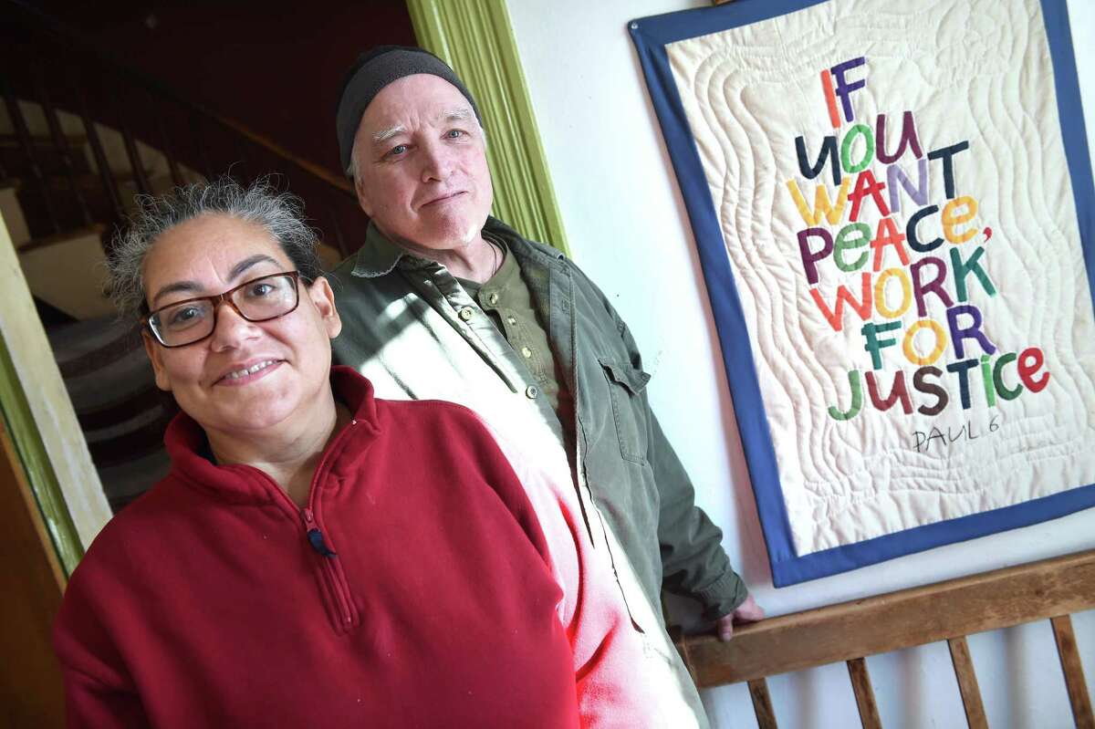New Haven Register persons of the year Luz Catarineau and her husband, Mark Colville, photographed at the Amistad Catholic Worker House, which also is their home, on Rosette Street in New Haven on Dec. 23, 2019.