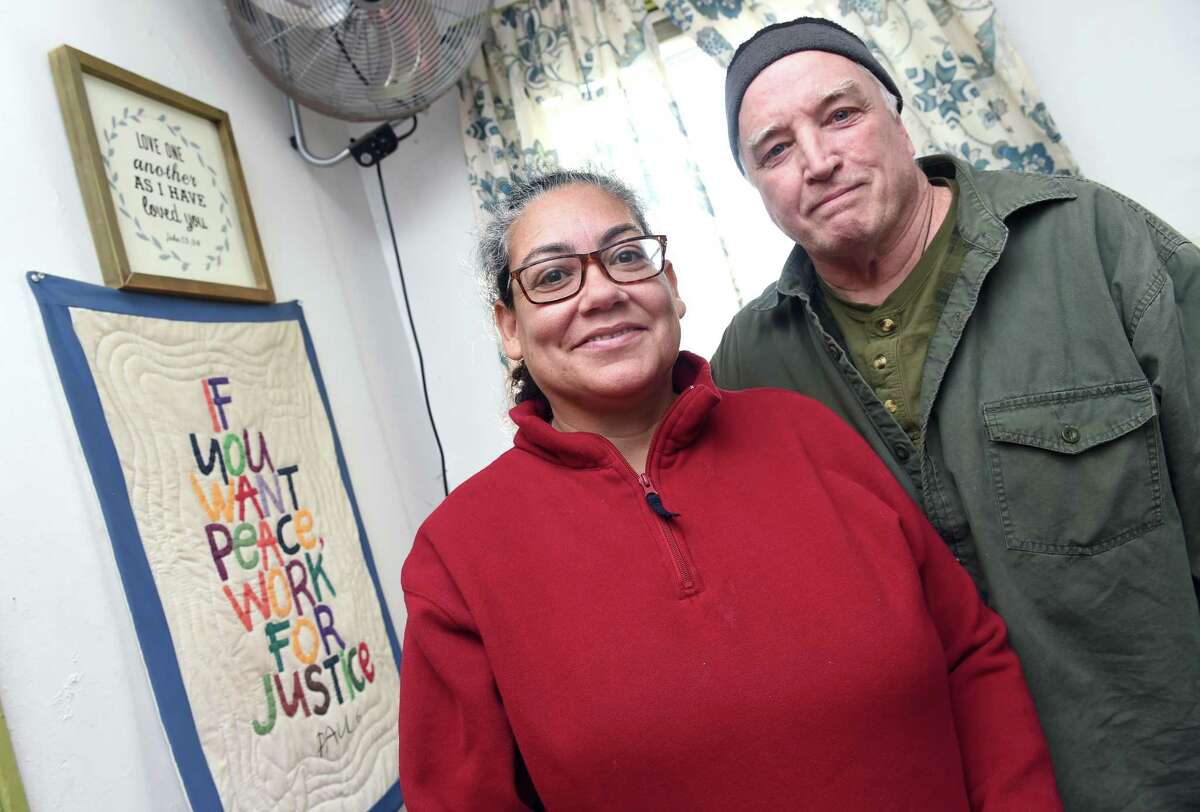 New Haven Register persons of the year Luz Catarineau and her husband, Mark Colville, photographed at the Amistad Catholic Worker House, which also is their home, on Rosette Street in New Haven on Dec. 23, 2019.