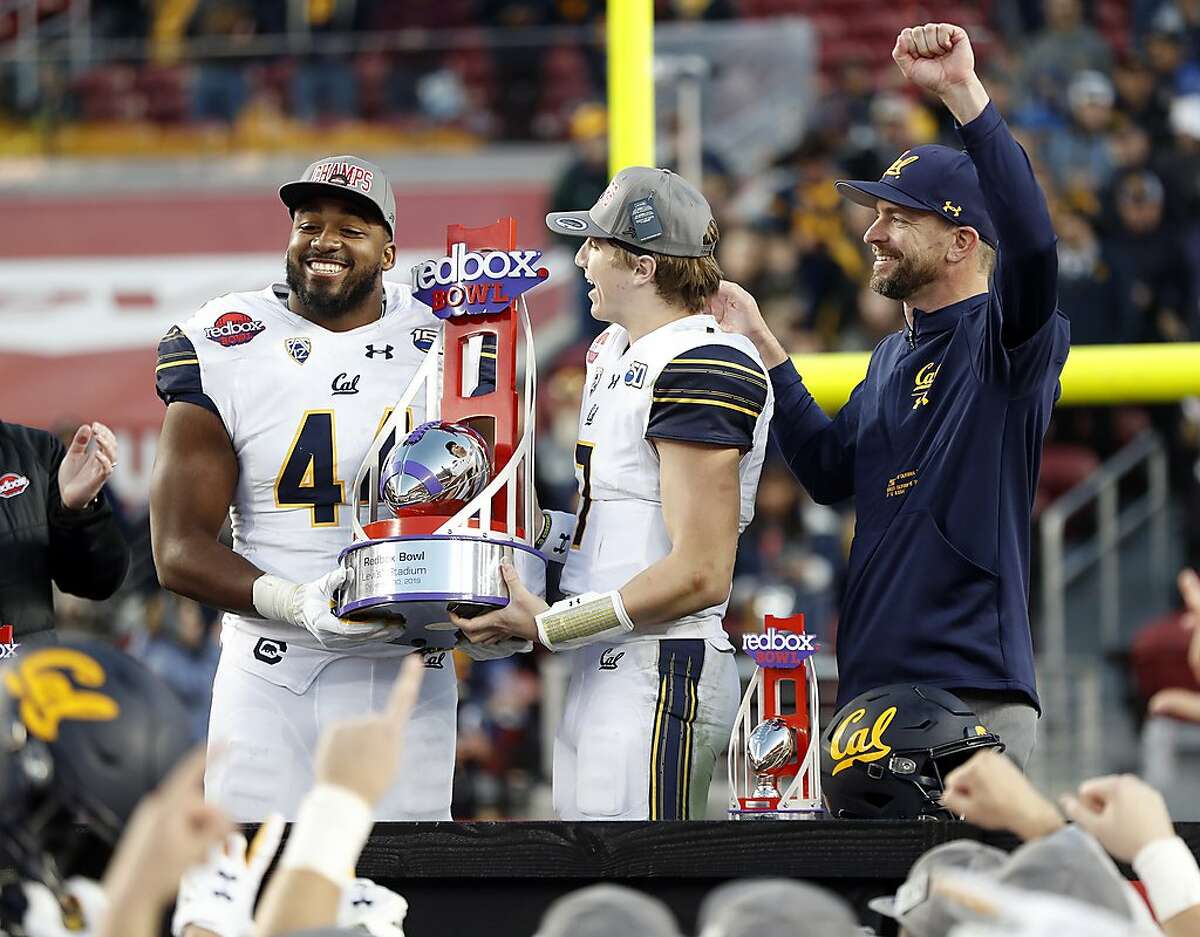 California's Zeandae Johnson, Chase Garbers and head coach Justin Wilcox celebrate Cal's 35-20 win over Illinois in Redbox Bowl at Levi's Stadium in Santa Clara, Calif., on Monday, December 30, 2019.
