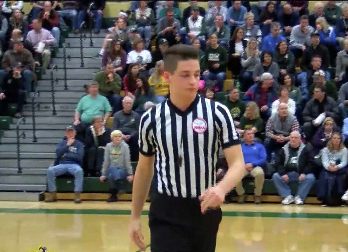 Northwood University sophomore Christian Smith, 19, officiates a boys' basketball game between Dow High and Midland High during the 2018-19 season.