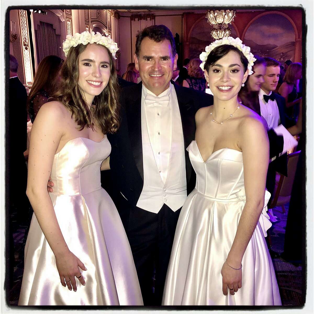 Christian Huebner with his twin debutante daughters, Frances (left) and Katharine Huebner at the Cotillion Debutante Ball. Dec. 21, 2019.