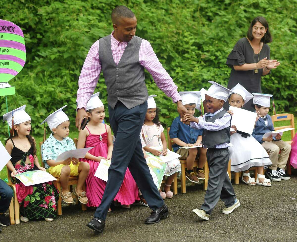 Above, Kyle Johnson receives a helping hand from his father, Loushen Johnson, while walking to get his diploma on stage at the Family Centers Head Start preschool graduation ceremony at Armstrong Court in Chickahominy on June 20.