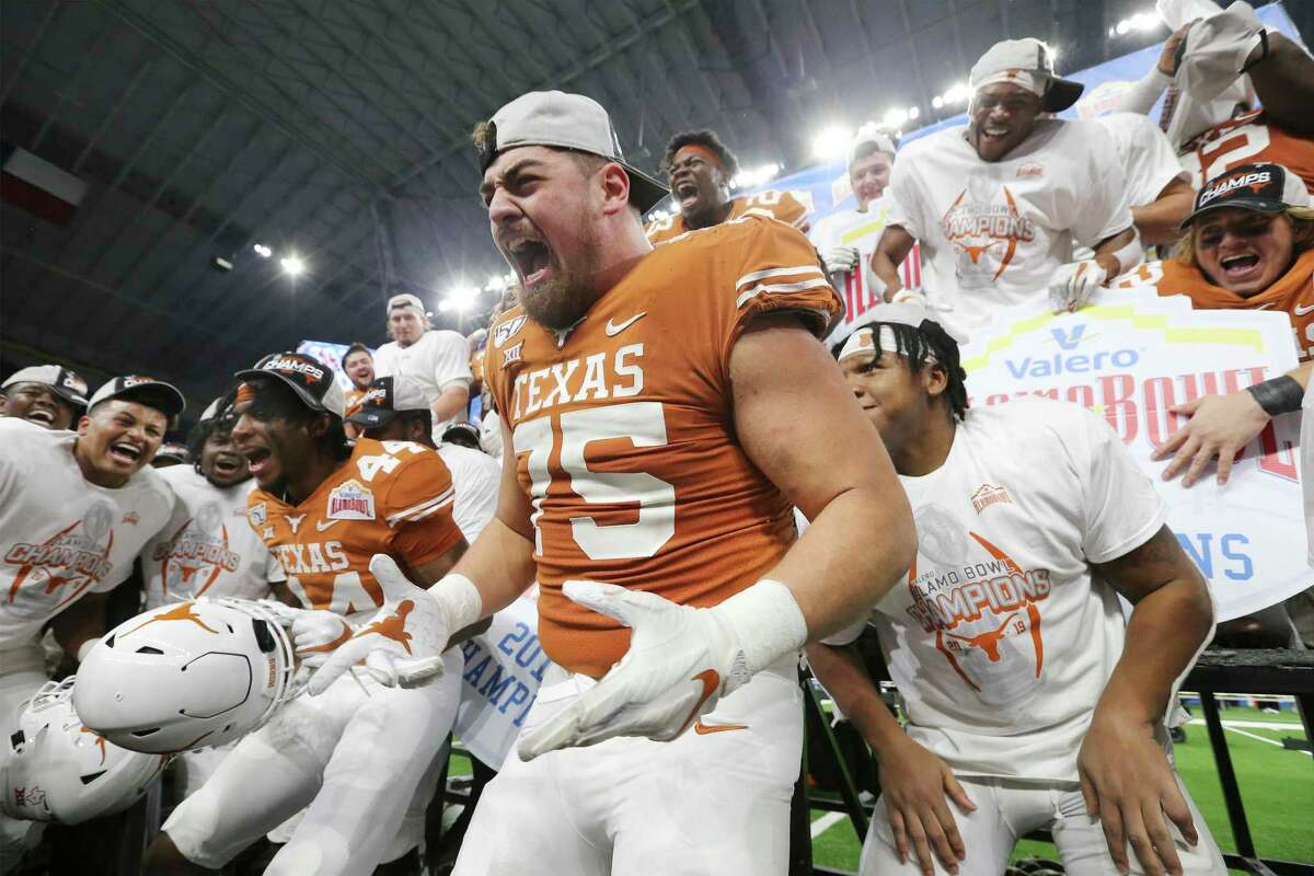 Texas Longhorns' Junior Angilau (75) leads the team in a chant after the Longhorns defeat the Utah Utes at the 2019 Valero Alamo Bowl at the Alamodome on Tuesday, Dec. 31, 2019. The Longhorns defeated the Utes, 38-10, to win the 2019 Valero Alamo Bowl.