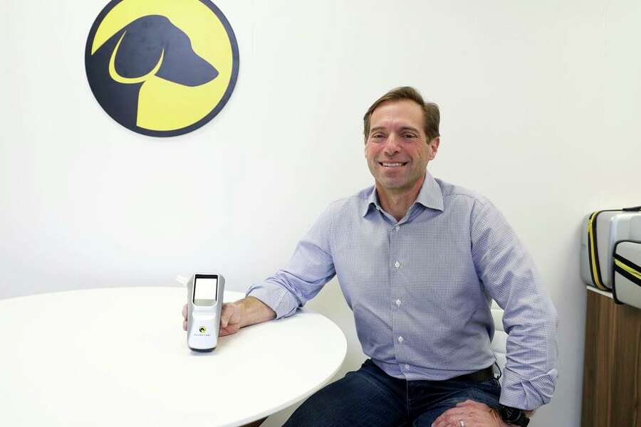 Dr. Mike Lynn, CEO and founder of Hound Labs, displays his company’s dual alcohol/marijuana breath analyzer.