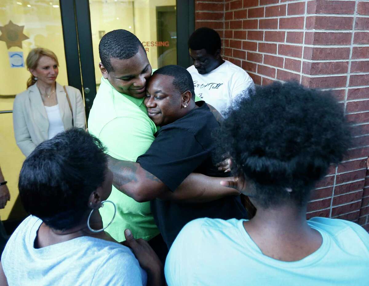 Alfred Brown walks out of the Harris County Jail and hugs Albred Carroll on Monday, June 8, 2015, in Houston. ( Karen Warren / Houston Chronicle )
