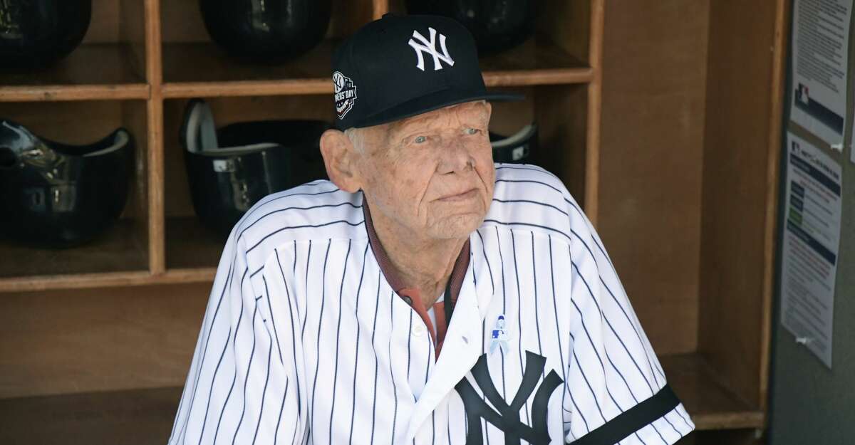 FILE - In this Sunday, June 17, 2018, file photo, New York Yankees' Don Larsen sits in the dugout before the Yankees' Old-Timers' Day baseball game at Yankee Stadium in New York. Larsen, the journeyman pitcher who reached the heights of baseball glory in 1956 for the Yankees when he threw a perfect game and only no-hitter in World Series history, died Wednesday, Jan. 1, 2020. He was 90. (AP Photo/Bill Kostroun, File)