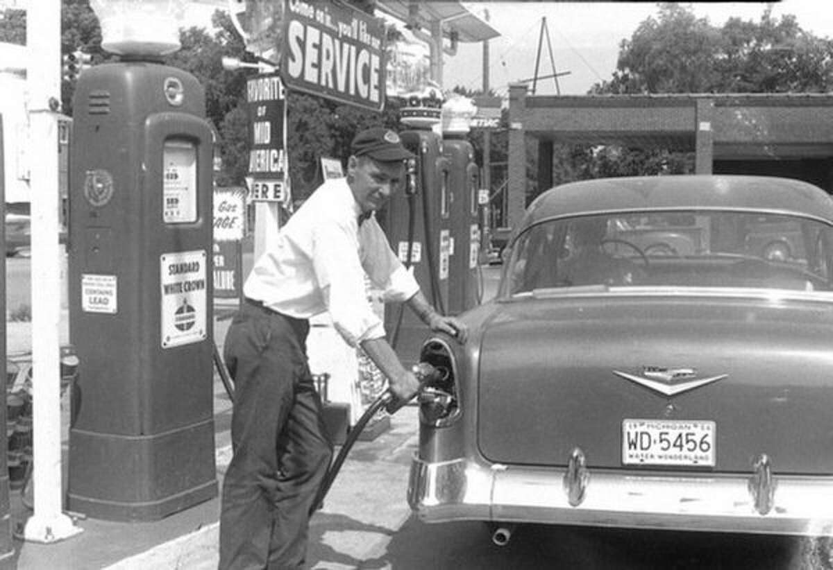 Rich "Dick" Currie is pictured in this 1956 photo pumping gas at a station he owned in Big Rapids. Currie's death in 1996 prompted his son, Pat, to post an "RIP" message on the marquee of the gas station he owned in Big Rapids. More than 20 years later, Pat Currie continues to use his gas station's marquee to inform drivers and passersby of local happenings. (Courtesy photo)