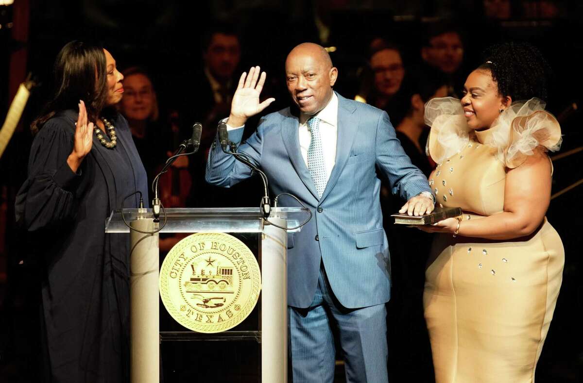 Judge Vanessa Gilmore leads the swearing-in for Mayor Sylvester Turner with his daughter, Ashley Turner, during the inauguration for the mayor, City Controller Chris Brown, and a number of city council members at the Wortham Center Thursday, Jan. 2, 2020.