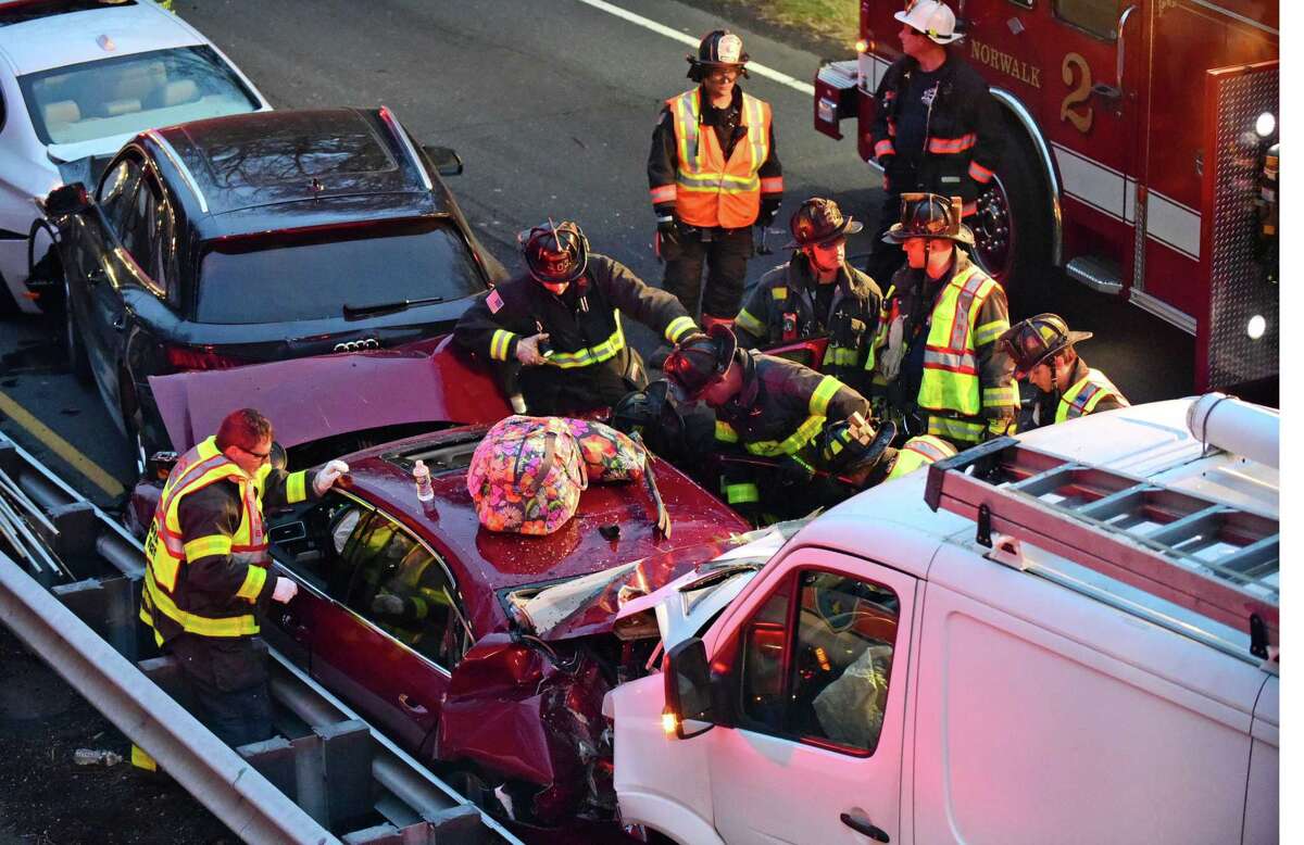 Emergency personnel including theNorwalk and Westport Fire Department firefighters respond to the scene of a five car accident on the Merritt Parkway North between exits 40 and 41 Tuesday, November 19, 2019, in Norwalk, Conn. Several persons were extracted from one of the vehicles and sent to Norwalk Hospital for evaluation.