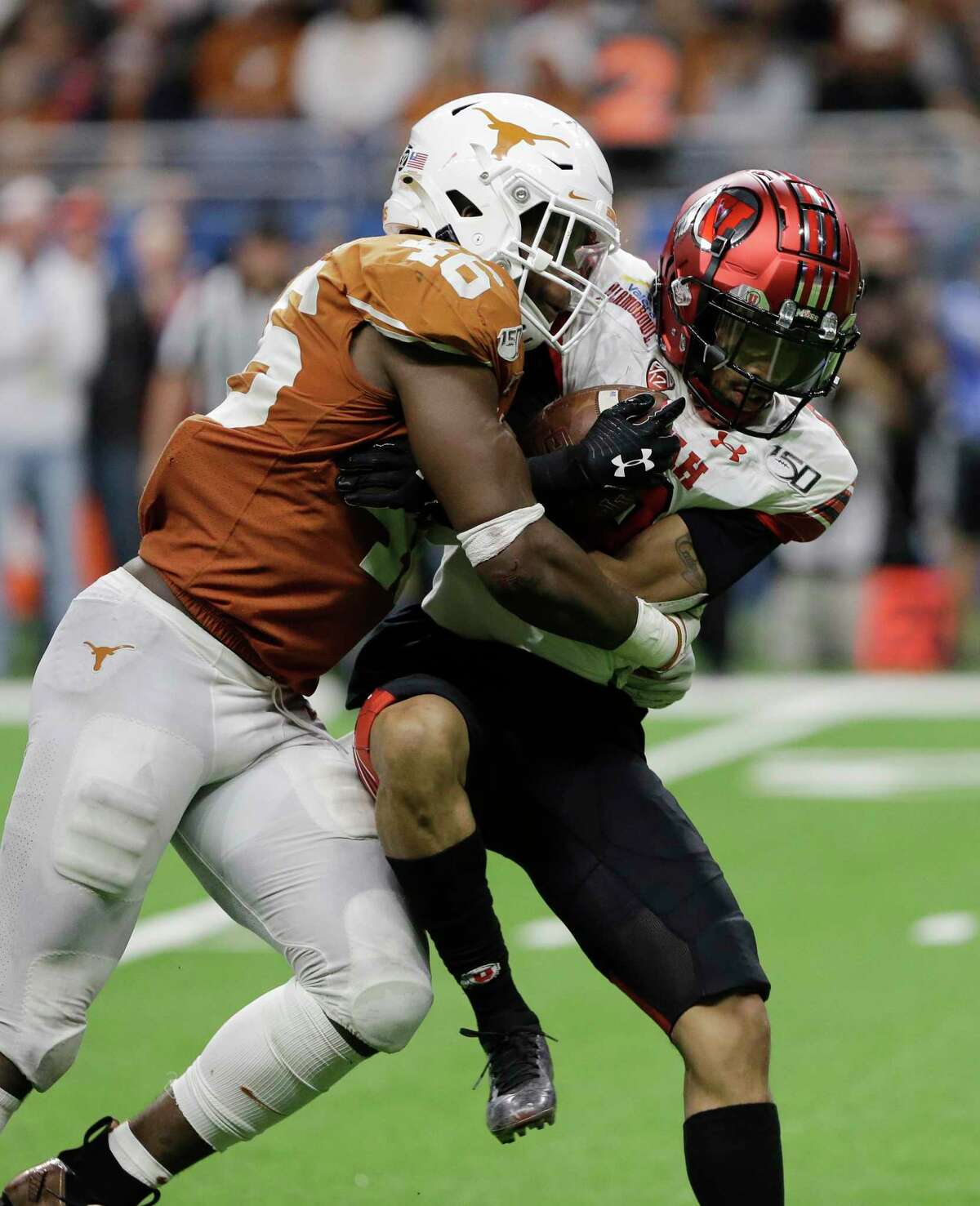 Texas linebacker Joseph Ossai (46) hits Utah wide receiver Derrick Vickers (8) during the second half of the Alamo Bowl NCAA college football game in San Antonio, Tuesday, Dec. 31, 2019. (AP Photo/Austin Gay)