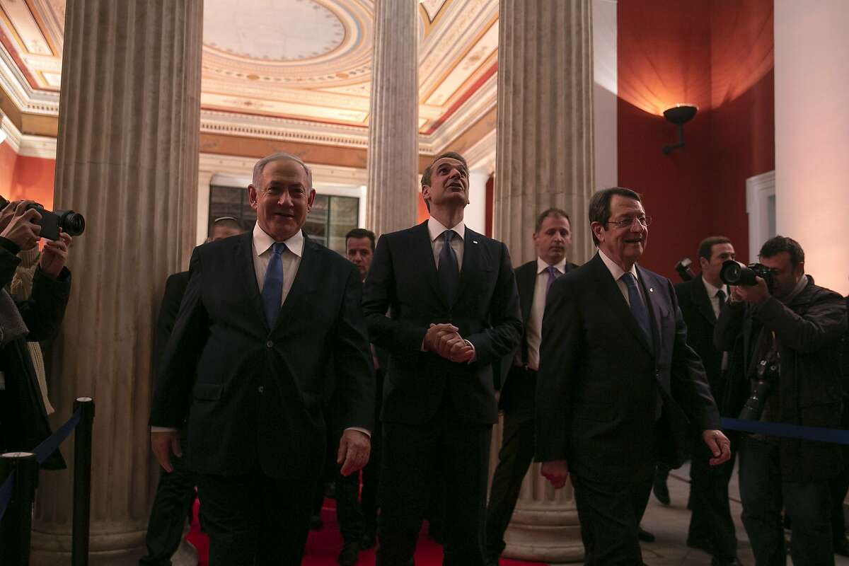 Israeli Prime Minister Benjamin Netanyahu, left, Greece's Prime Minister Kyriakos Mitsotakis, center, and Cypriot President Nicos Anastasiadis arrive for a signing ceremony at Zappeio hall, in Athens, Thursday, Jan. 2, 2020. The leaders of Greece, Israel and Cyprus met in Athens Thursday to sign a deal aiming to build a key undersea pipeline, named EastMed, designed to carry gas from new rich offshore deposits in the southeastern Mediterranean to continental Europe. (AP Photo/Yorgos Karahalis)