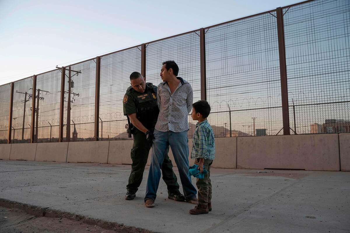- AFP PICTURES OF THE YEAR 2019 - Jos�, 27, with his son Jos� Daniel, 6, is searched by US Customs and Border Protection Agent Frank Pino, May 16, 2019, in El Paso, Texas. Father and son spent a month trekking across Mexico from Guatemala. - About 1,100 migrants from Central America and other countries are crossing into the El Paso border sector each day. US Customs and Border Protection Public Information Officer Frank Pino, says that Border Patrol resources and personnel are being stretched by the ongoing migrant crisis, and that the real targets of the Border Patrol are slipping through the cracks. (Photo by Paul Ratje / AFP) (Photo by PAUL RATJE/AFP via Getty Images)