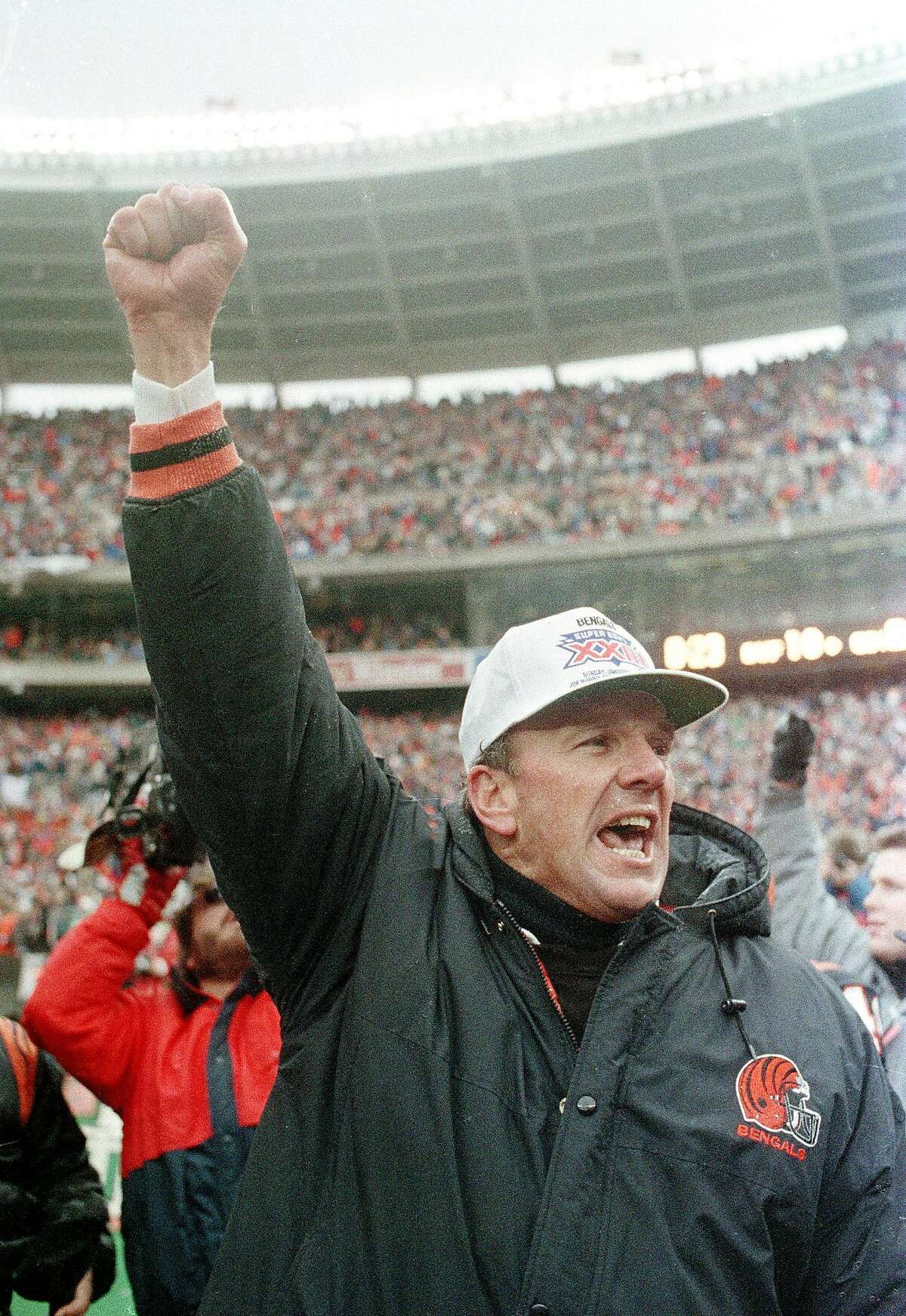 ** FILE ** Cincinnati Bengals coach Sam Wyche stabs the air with his fist after the Bengals beat the Buffalo Bills 21-10 to win the AFC Champoinship in this Jan. 8, 1989 photo, in Cincinnati. A healthier, happy Sam Wyche is still in the game _ even if his to-do list at Pickens High includes things he never would have thought about in the NFL. Sweep out the locker rooms? You bet. Simplify his vast playbook for the high school game? Easily done. Watch his starting quarterback take a few days away from camp to play baseball? Not a problem. (AP Photo/AL Behrman)