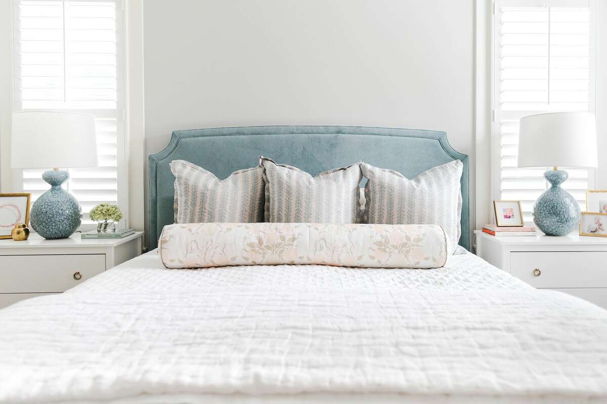 Cool blues add accents to a calm, neutral master bedroom.
