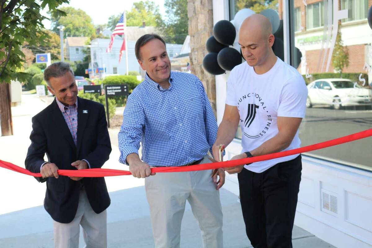Joshua Takacs, right, marks in September 2019 the opening of his Family Functional Fitness in Greenwich, Conn., joined by First Selectman Peter Tesei, center, and state Rep. Fred Camillo.