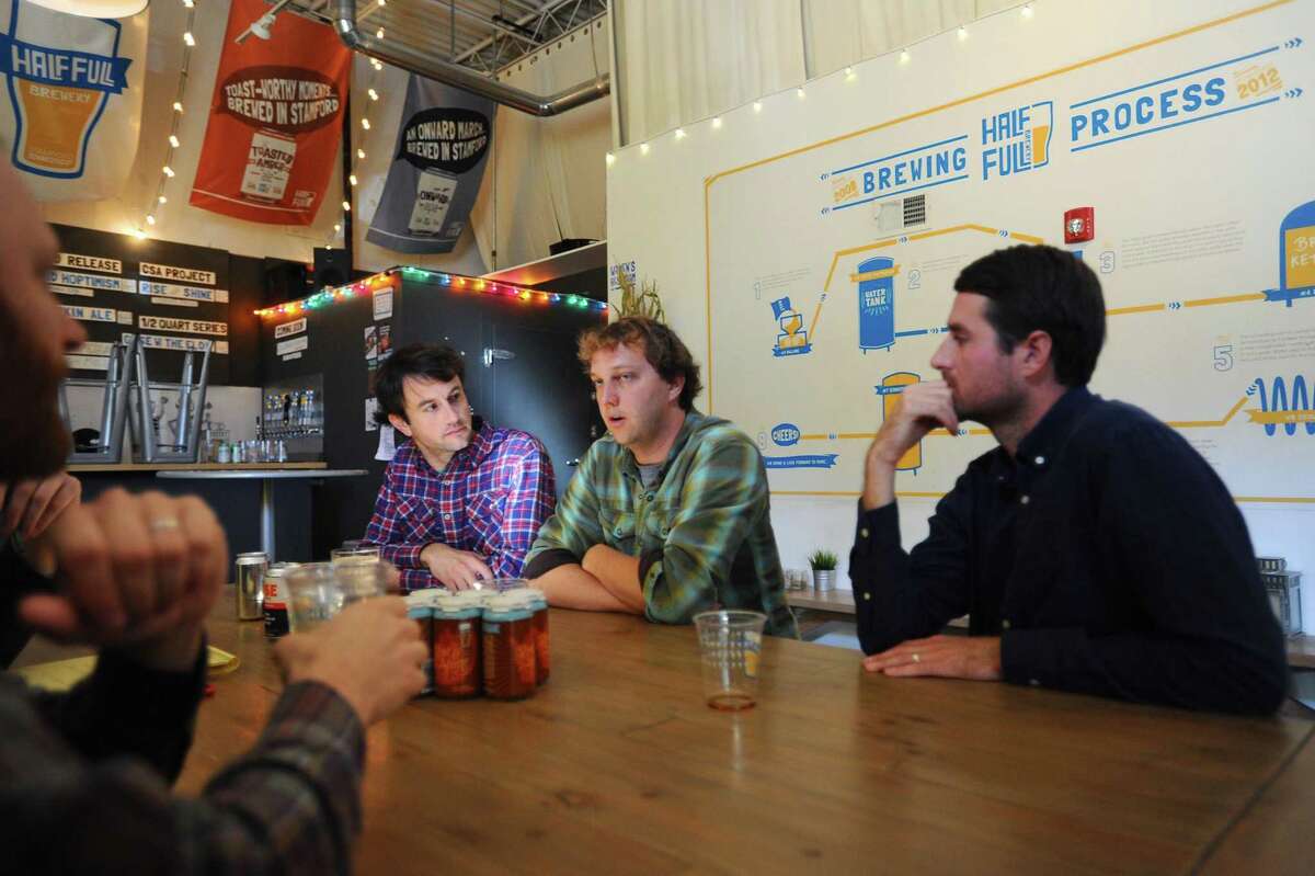 Brewmaster and Greenwich-based Rise Coffee co-founder Grant Gyesky, center, discusses the partnership with Half Full Brewery to make a coffe infused beer inside Half Full Brewery in Stamford, Conn. on Tuesday, Oct. 11, 2016. Also pictured are Half Full marketing director Jordan Giles, right, and Rise Coffee head of product development Stuart DeVan.