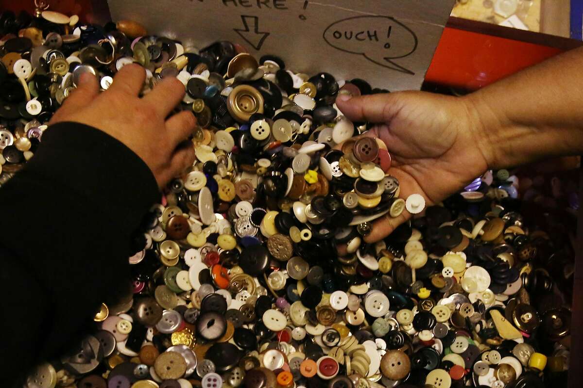 Laura Vasquez (right) and her daughter Chenoa Carhart (left), both of San Francisco, look through a bin of buttons while shopping at SCRAPS on Thursday, December 12, 2019 in San Francisco, Calif.