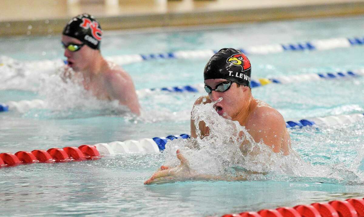 New Canaan’s Bart Codd and Greenwich’s Tom Lewis compete in the boys 100 meter breast stroke during a dual swim/dive meet at the New Canaan YMCA Valles Natatorium on Friday in New Canaan.
