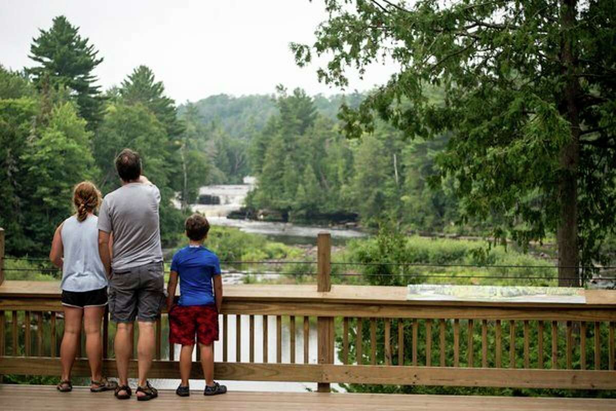 A family takes in the scenic Lower Falls at Tahquamenon Falls State Park in the eastern Upper Peninsula, among the many memory-making destinations in Michigan state parks. (Michigan DNR/Courtesy Photo)
