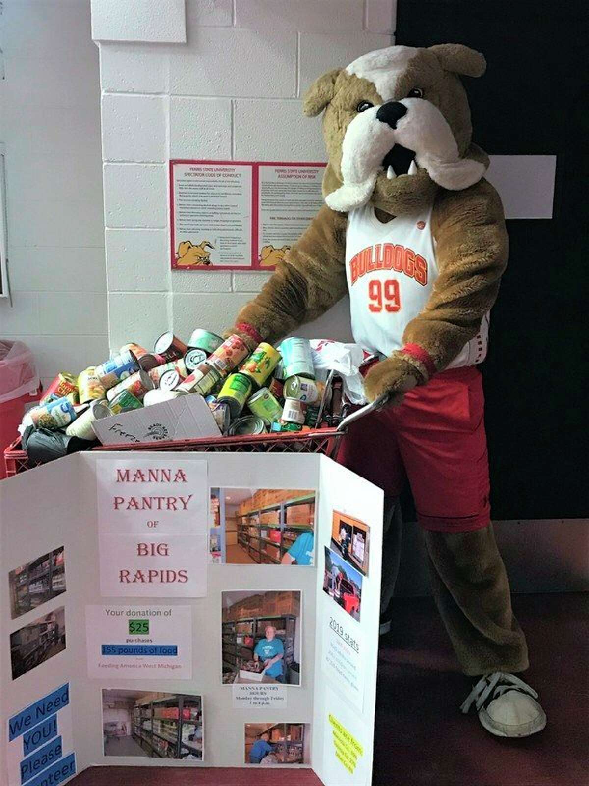 Ferris State University mascot Brutus smiles at the 307 pounds of canned goods Manna Pantry of Big Rapids received during Thursday night's basketball game. (Courtesy photo)
