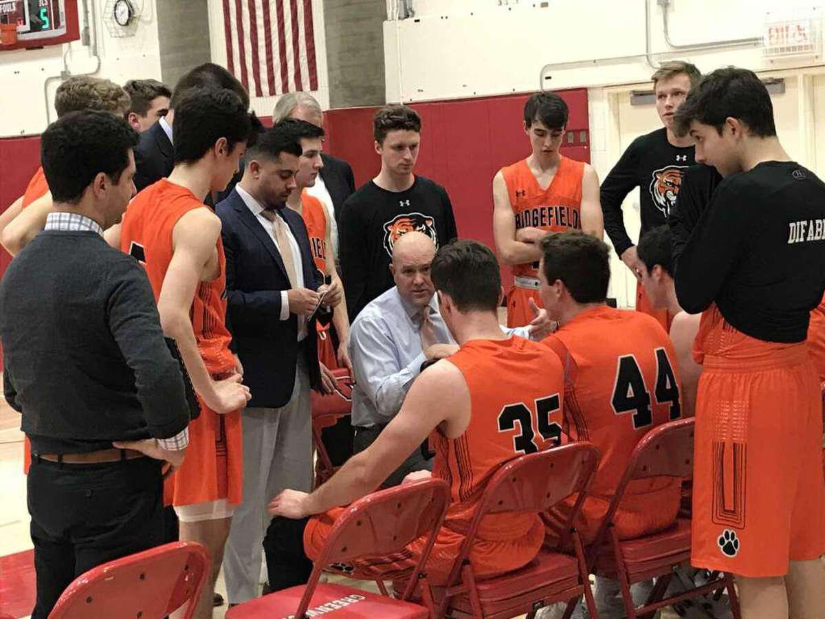 Ridgefield boys basketball coach Andrew McClellan addresses his team during the closing minutes of the Tigers game against Greenwich on Friday, January 3, 2020, in Greenwich.