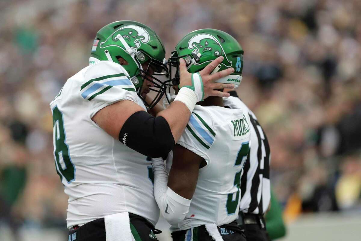 Tulane offensive lineman Christian Montano of Orange, left, congratulates wide receiver Darnell Mooney after he scored on a touchdown catch against Navy. Montano was one of eight players cut by the NFL’s Pittsburgh Steelers on Sunday.
