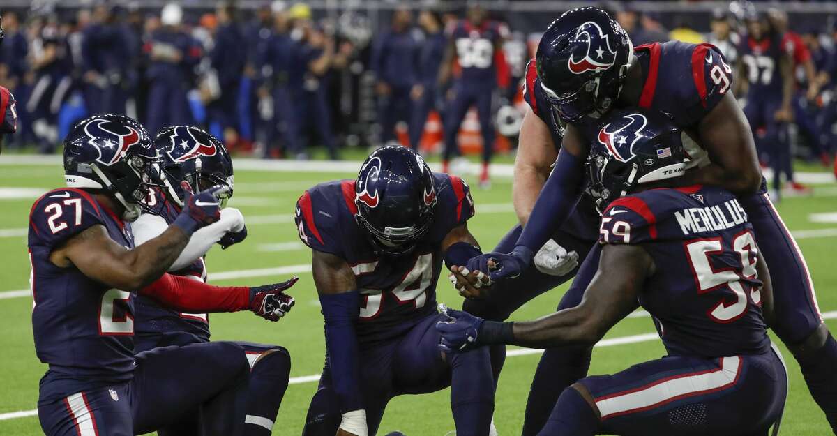 Houston Texans linebacker Jake Martin (54) and the rest of the defense celebrate Martin's sack of Buffalo Bills quarterback Josh Allen during the fourth quarter of an AFC wild card playoff game at NRG Stadium on Saturday, Jan. 4, 2020, in Houston.