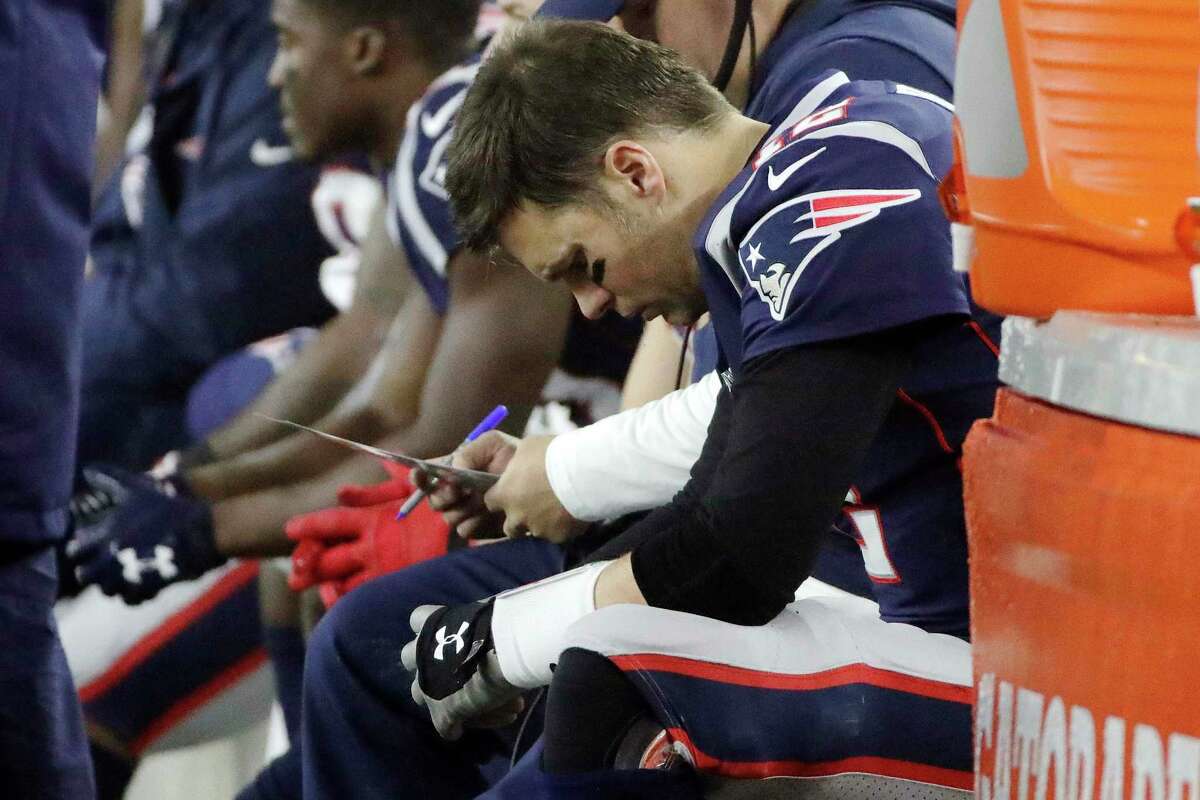 New England Patriots quarterback Tom Brady sits on the bench in the first half of an NFL wild-card playoff football game against the Tennessee Titans, Saturday, Jan. 4, 2020, in Foxborough, Mass. (AP Photo/Elise Amendola)