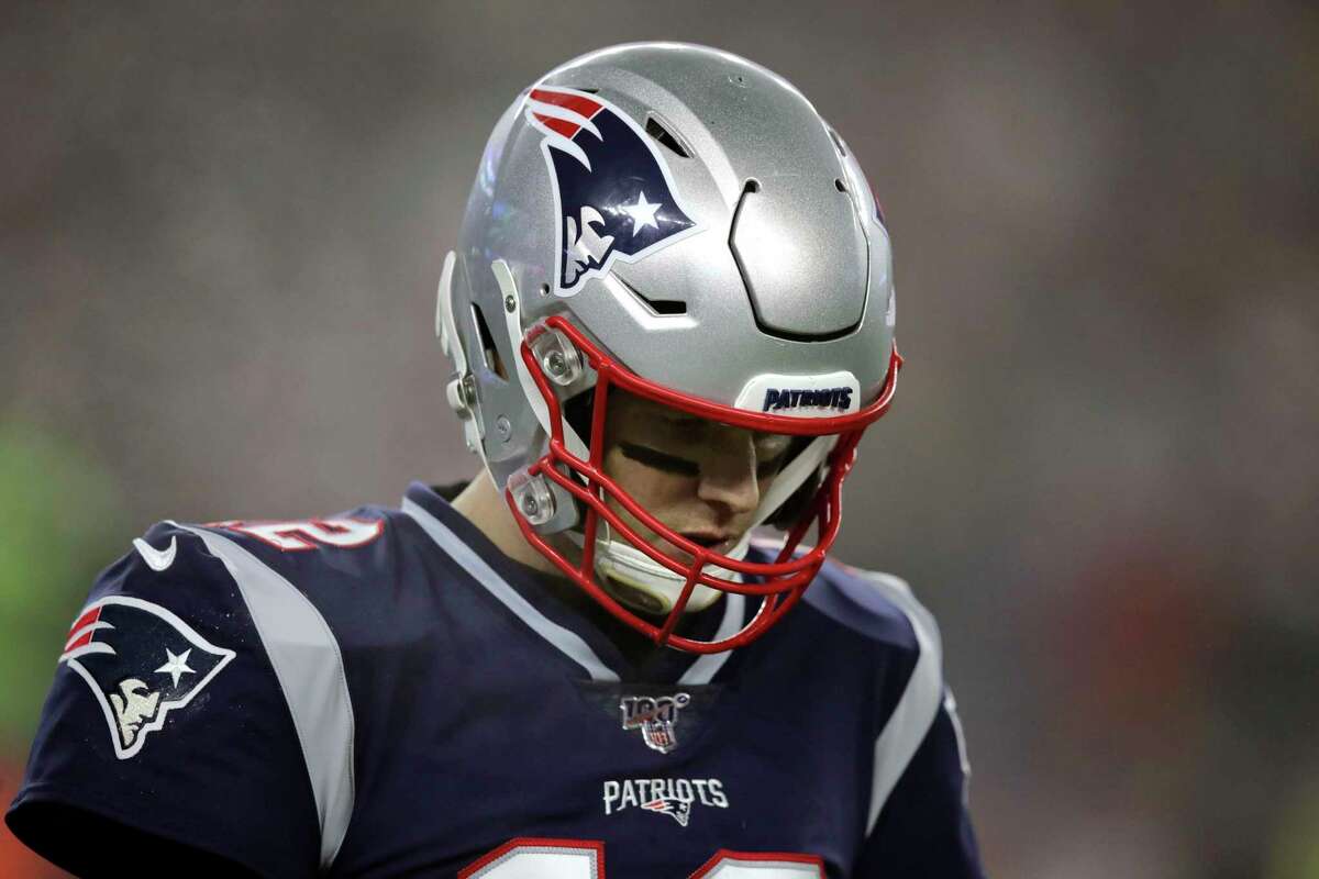 New England Patriots quarterback Tom Brady walks to the sideline after a series of plays in the first half of an NFL wild-card playoff football game against the Tennessee Titans, Saturday, Jan. 4, 2020, in Foxborough, Mass. (AP Photo/Charles Krupa)