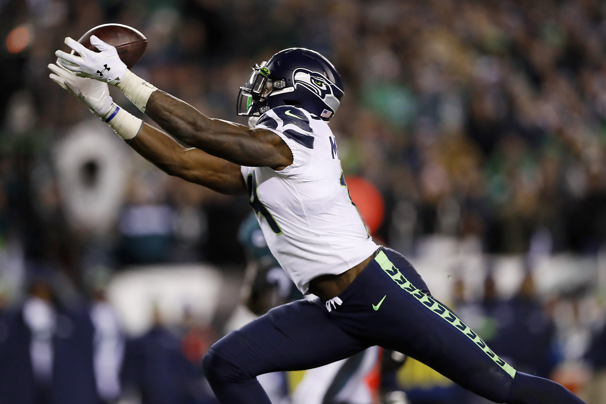 Seattle Seahawks' Jarran Reed (90) celebrates with Quinton Jefferson (99)  after Philadelphia Eagles' Josh McCown was sacked during the second half of  an NFL wild-card playoff football game, Sunday, Jan. 5, 2020