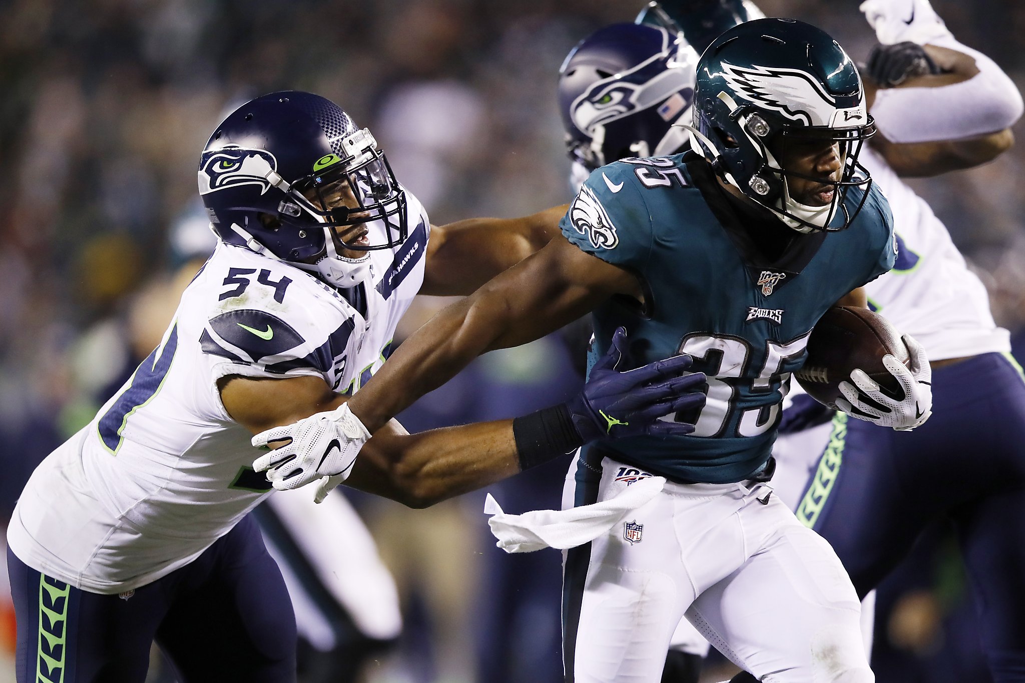 Seattle Seahawks' Jarran Reed (90) celebrates with Quinton Jefferson (99)  after Philadelphia Eagles' Josh McCown was sacked during the second half of  an NFL wild-card playoff football game, Sunday, Jan. 5, 2020