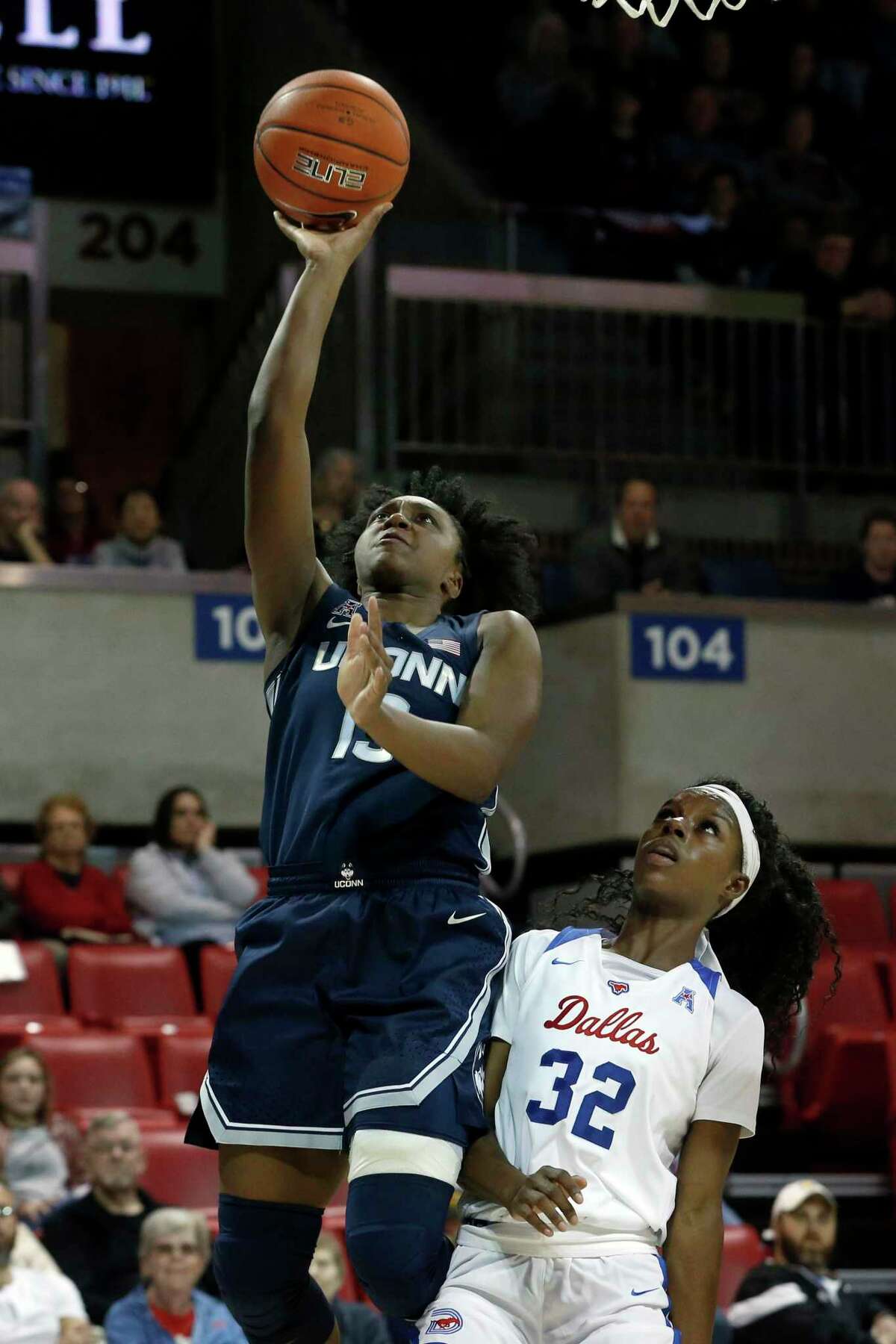 UConn guard Christyn Williams (13) scores in front of SMU guard Kayla White (32) during the second half of an NCAA college basketball game in University Park, Texas on Sunday.
