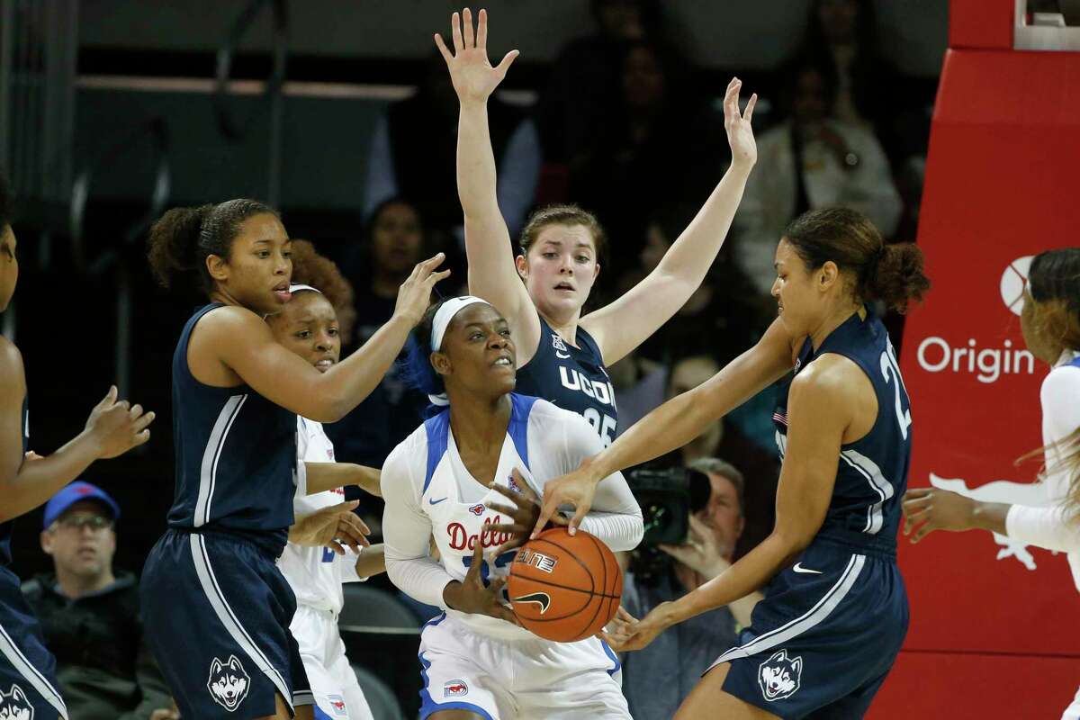 UConn’s Megan Walker (3) forward Kyla Irwin (25) and forward Olivia Nelson-Ododa (20) force a turnover by SMU forward Johnasia Cash (33), center, during the second half of an NCAA college basketball game in University Park, Texas on Sunday.