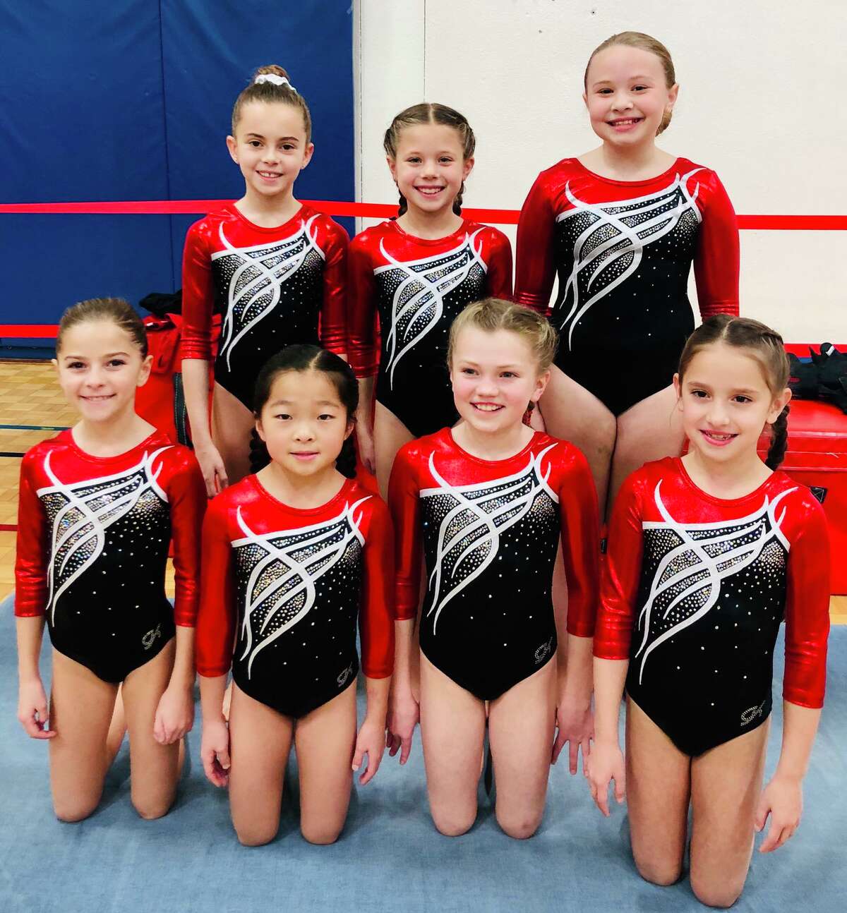 Wilton YMCA gymnasts Piper Young, Nora Walencikowski and Kensey Diglio (back row, left to right) and Allison Massaua, Brianna Shiue, Jane Carroll, and Lily Blessing (front row, left to right) competed for the first time at the Snowflake Invitational.