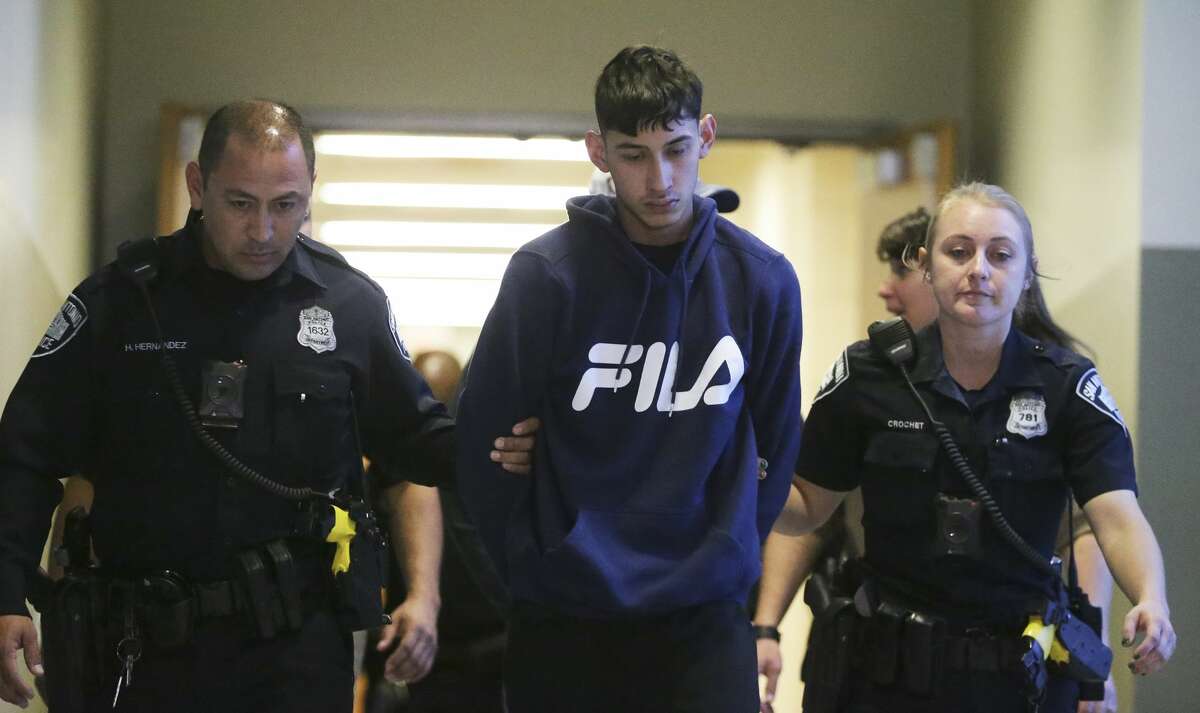 Cesar Gonzalez is led out of the downtown police department on Jan. 2, 2020 after his arrest involving a fatal New Year's night double fatality.