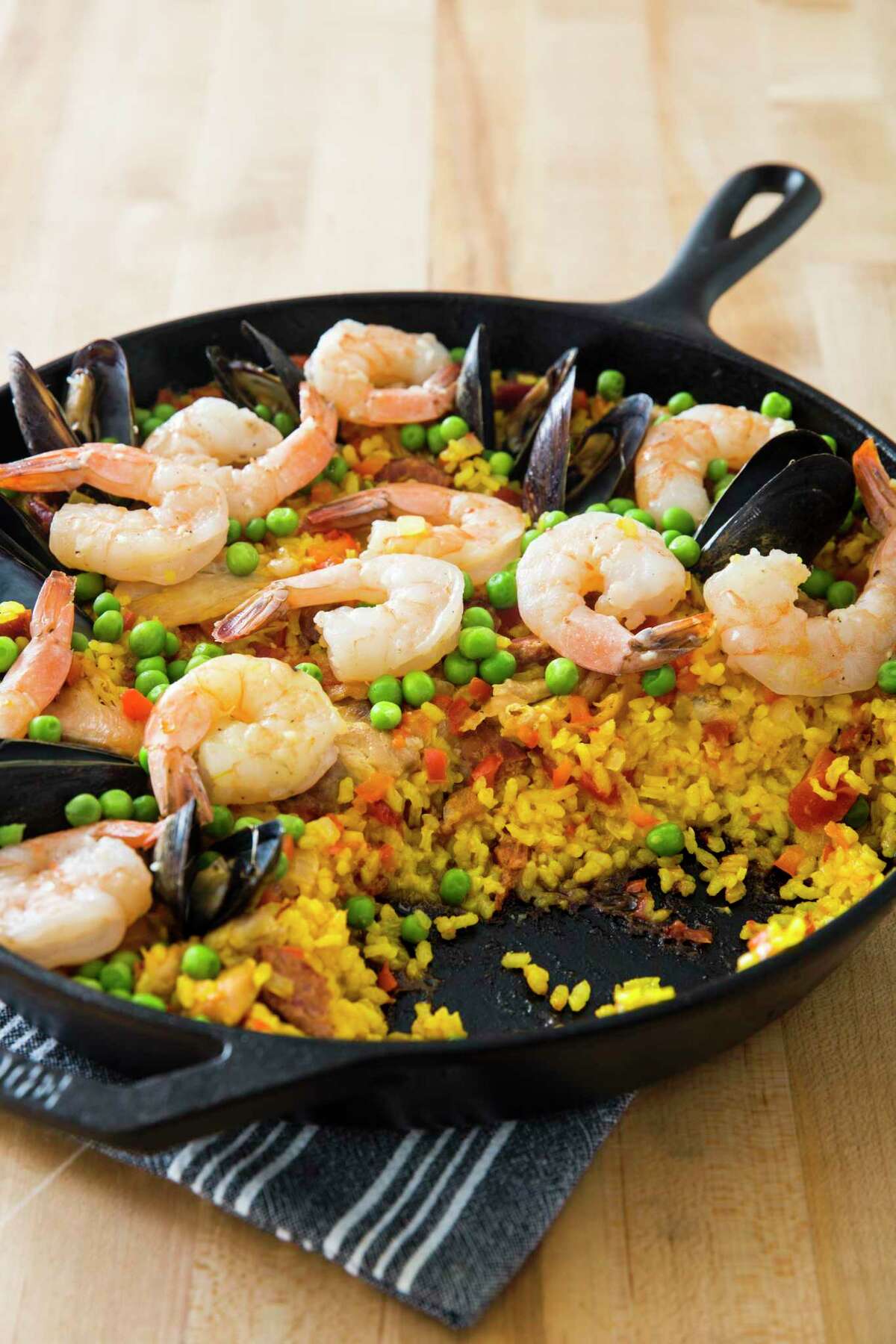 Paella recipe made in a cast iron pan from America's Test Kitchen.