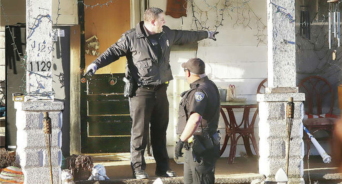 An Alton Police Department lieutenant gives orders to an officer on the front porch of a house in the 1100 block of Highland Ave. where a man, believed to be in his late 60s, was found dead inside the home early Monday morning in Alton. Alton Police Chief Jason Simmons described the scene as the “first homicide of the new year.” The man reportedly missed his dialysis appointment, prompting the business to ask police to check on the man’s welfare, which led to the discovery. Alton Police detectives and Illinois State Police Crime Scene Investigators worked and processed the crime scene into the early afternoon.