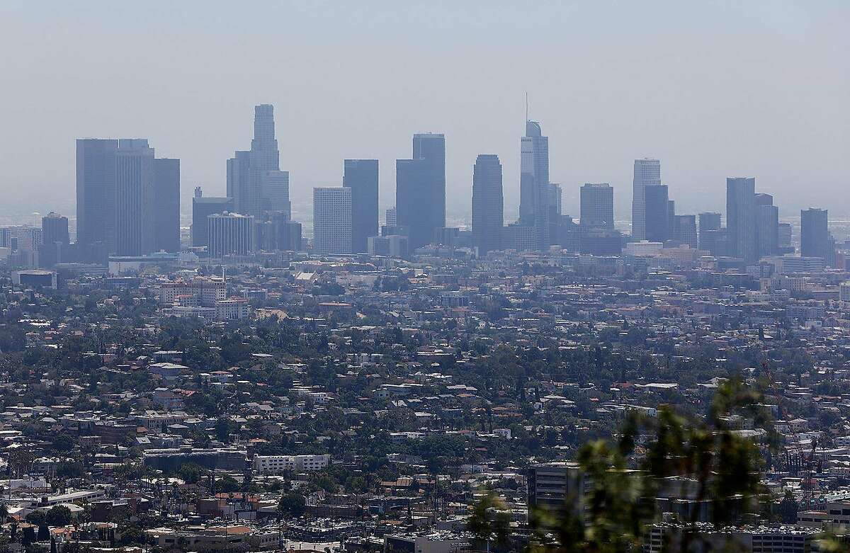 The downtown Los Angeles, Calif. skyline is seen from Griffith Observatory on Monday, July 1, 2019. In a letter to Mary Nichols, chairwoman of the California Air Resources Board, obtained by McClatchy, the EPA said the two sides "have made great progress" toward resolving the backlog of "outdated, unnecessary or deficient" reports on the state's plans to combat pollutants. (Christina House/Los Angeles Times/TNS)