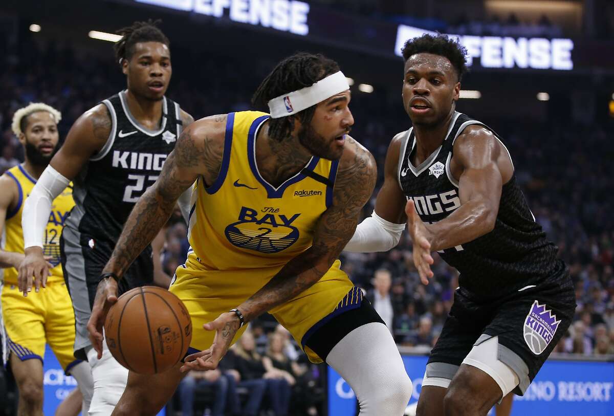 Golden State Warriors center Willie Cauley-Stein, front left, looks to pass against Sacramento Kings guard Buddy Hield, right, during the first quarter of an NBA basketball game in Sacramento, Calif., Monday, Jan. 6, 2020. (AP Photo/Rich Pedroncelli)