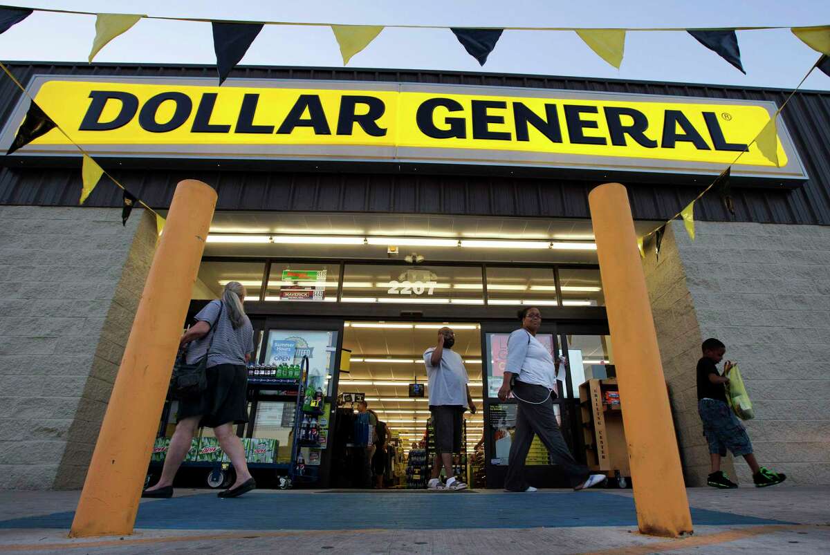 FILE - In this Wednesday, Sept. 25, 2013, file photo, customers exit a Dollar General store, in San Antonio. There’s now a bidding war for Family Dollar, with Dollar General offering about $9.7 billion for the discounter in an effort to trump Dollar Tree’s bid of $8.5 billion. (AP Photo/Eric Gay, File)