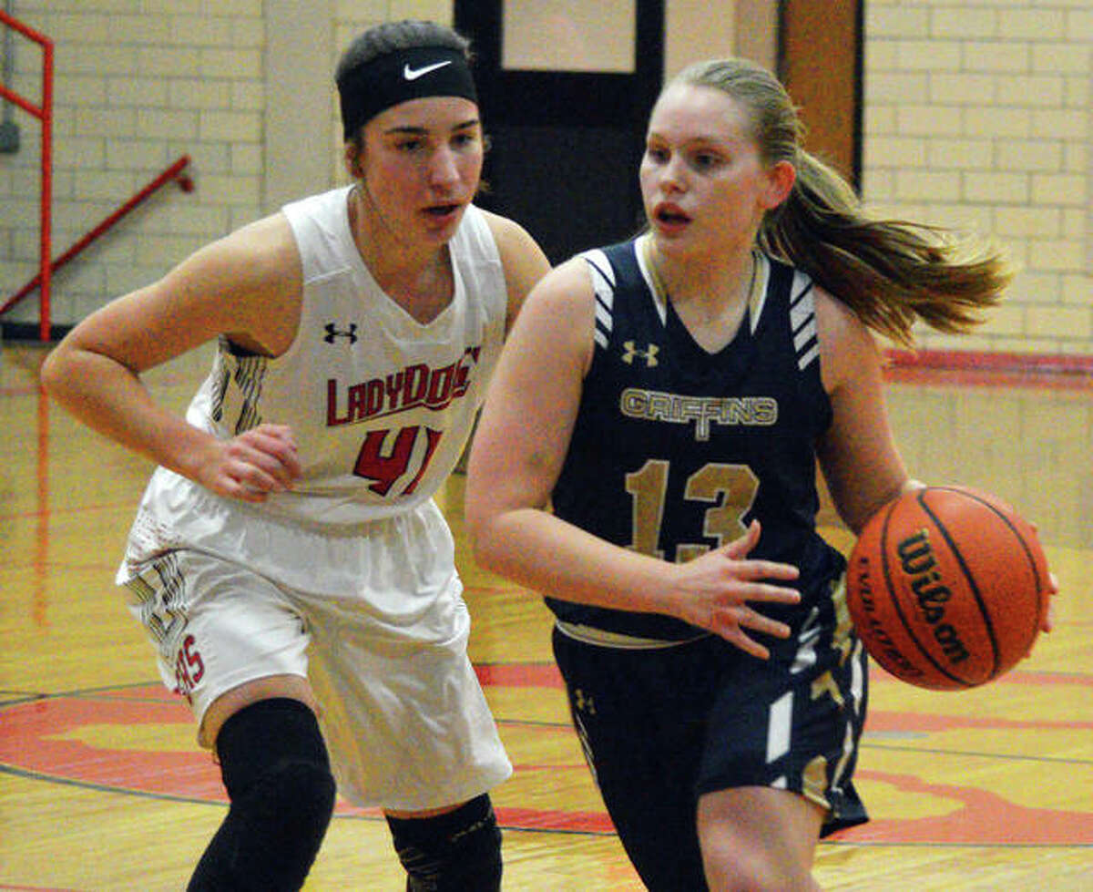 Father McGivney’s Rachel Maller (right) dribbles past’s Analise Best during Monday’s game in Staunton.