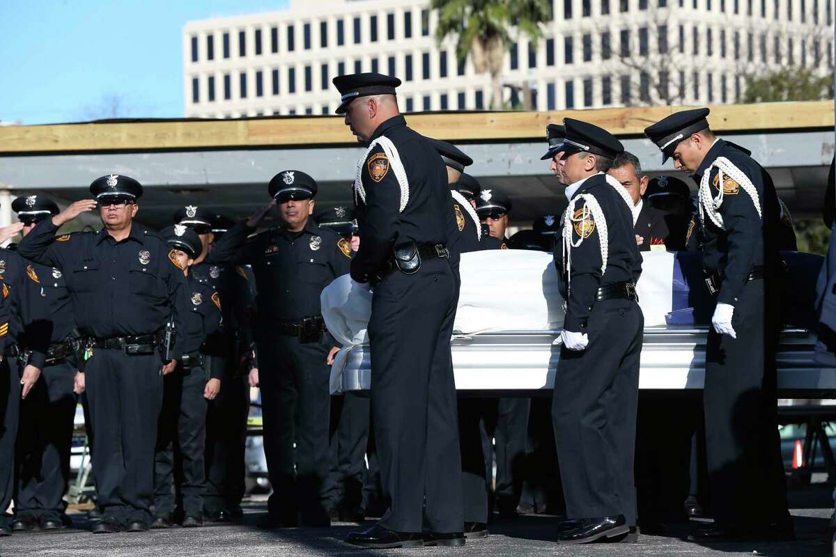 The casket of San Antonio Independent School District Police Det. Cliff Martinez is escorted out of the Porter Loring Mortuary on Jan. 7. He was killed early Dec. 21 as he attempted to break up a fight between two men while working security. The stories told about Martinez, since his death, abound with his friendliness, his eagerness to help, and how he made others feel. The trace evidence of a life that considered others.
