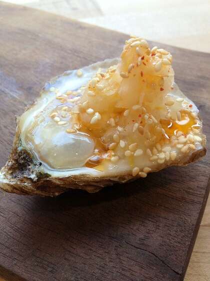 Oysters topped with spicy kohlrabi and sesame at State Bird Provisions. West Coast oysters will be a focus of the Anchovy Bar.