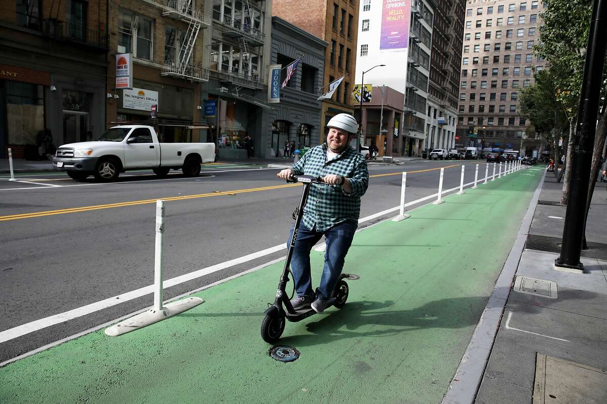 Alex Youn (name cq'd), communications and public affairs, Lime, demonstrates a new Lime scooter, near Mission and Second streets, that is designed for people with mobility issues in San Francisco, Calif., on Tuesday, January 7, 2020. The scooter can be reserved and the company will drop it off and pick it up from wherever you need it after 24 hours.
