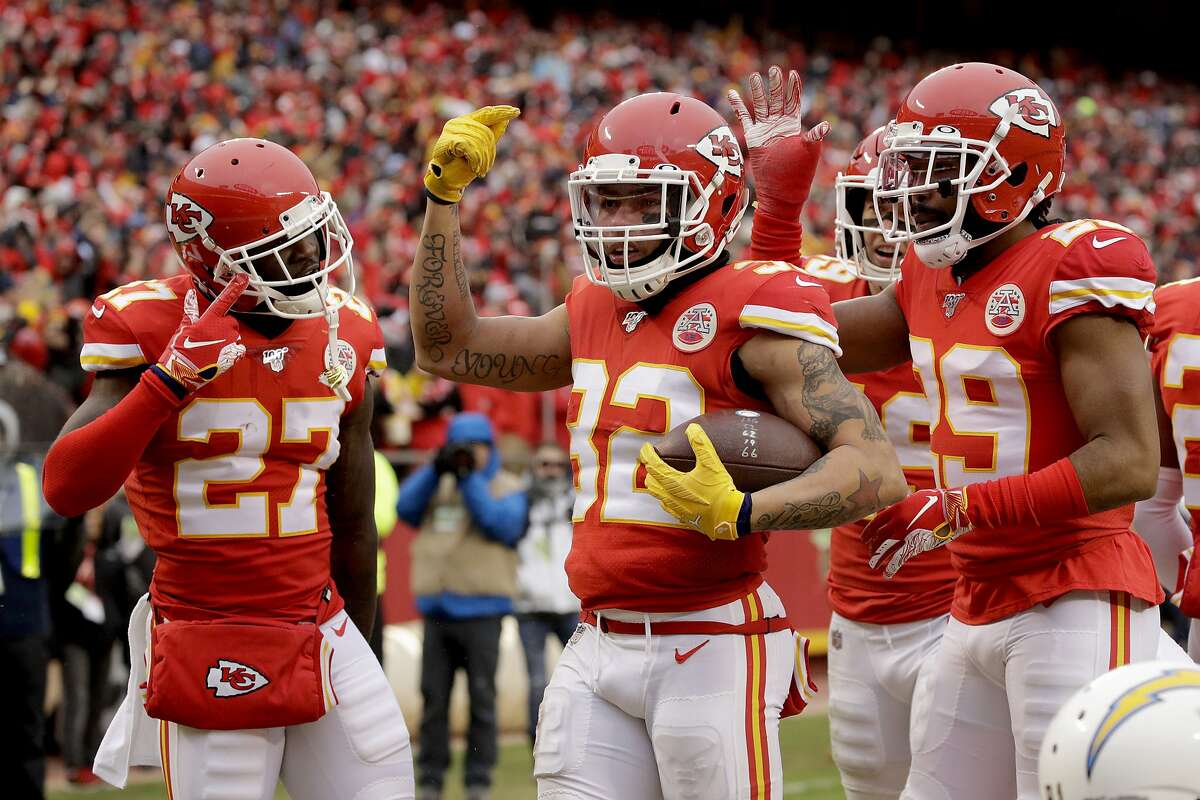 Kansas City Chiefs safety Tyrann Mathieu, center, celebrates between cornerback Rashad Fenton (27) and cornerback Kendall Fuller (29) after he intercepted a pass intended for Los Angeles Chargers wide receiver Mike Williams during the first half of an NFL football game in Kansas City, Mo., Sunday, Dec. 29, 2019. (AP Photo/Charlie Riedel)