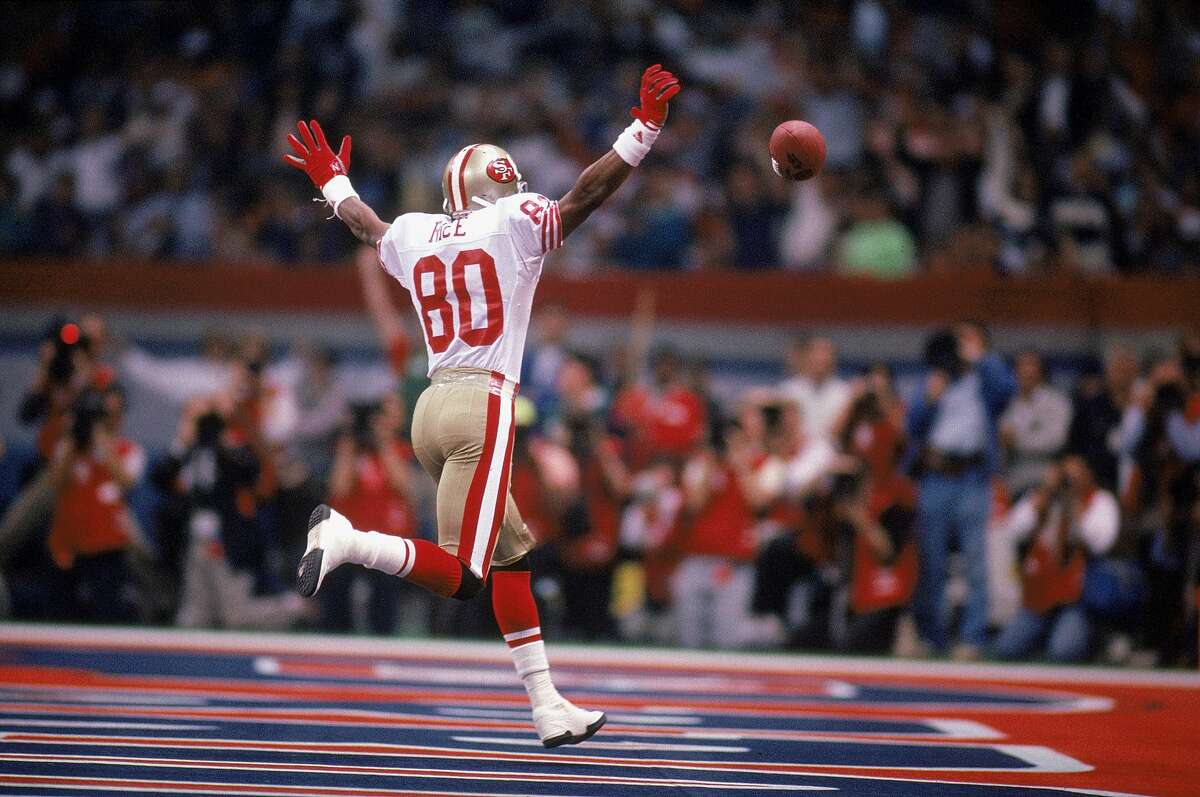 NFL FILE: Jerry Rice (80) and Steve Young (8) of the San Francisco 49ers  during Super Bowl XXIX at Joe Robbie Stadium in Miami, Florida. Young threw  a record 6 touchdowns and