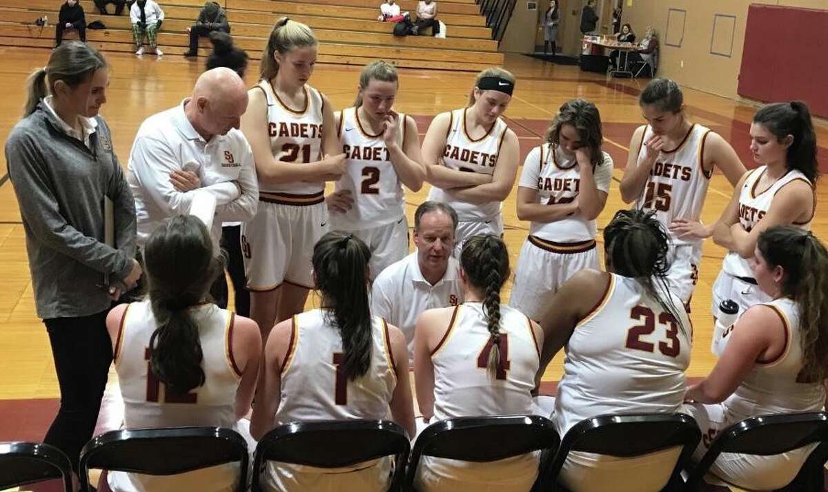 St. Joseph coach Chris Lindwall talks to his team during timeout in game with Trinity Catholic.