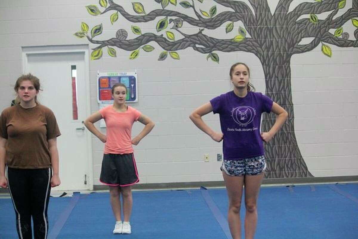 Evart cheerleaders preparing for a practice on Friday at the school include (from left) Emily Beemer, Madison Hunt and Mari Flachs. (Herald Review photo/John Raffel)