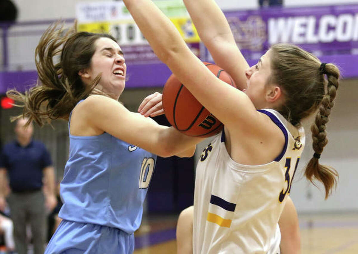 Jersey’s Abby Manns (left) looses control of the basketball while going up for a shot over CM’s Jackie Woelfel in the first quarter Tuesday night in a Mississippi Valley Conference girls basketball game in Bethalto.